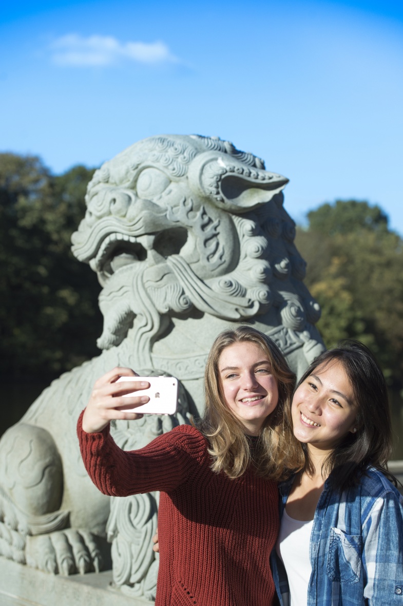Undergraduate students taking selfies at the Ningbo Lions, University Park