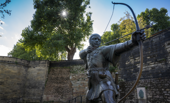 A statue of Robin Hood aiming a bow and arrow