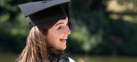 Graduating student laughing wearing her cap