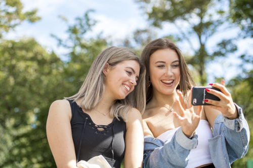 Two students smiling for a selfie