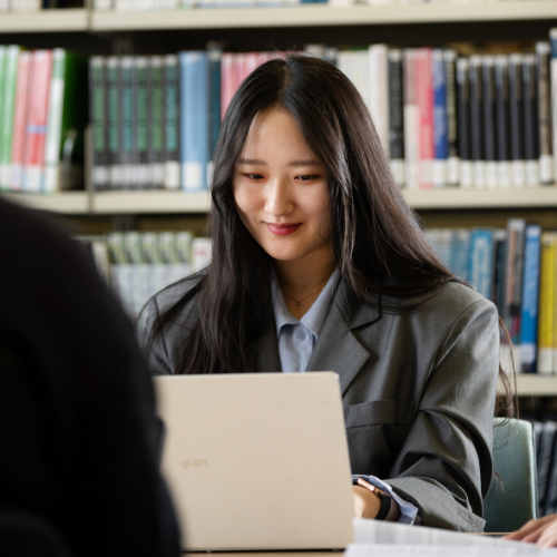 Students on laptop in library