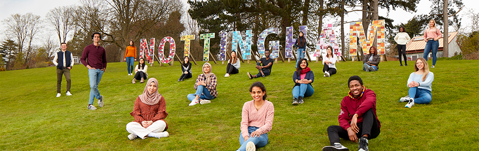 A group of international students in front of the Nottingham sign at University Park Campus