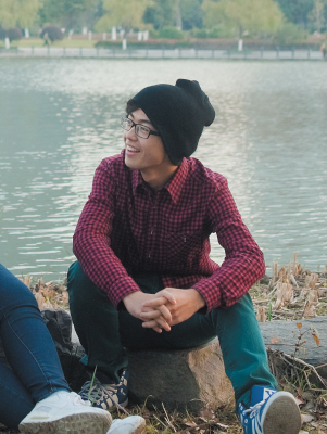 Student sitting down outside by river