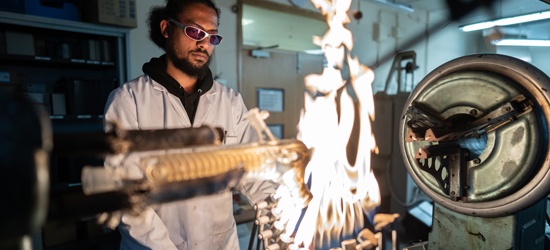 Technician student in lab with fire