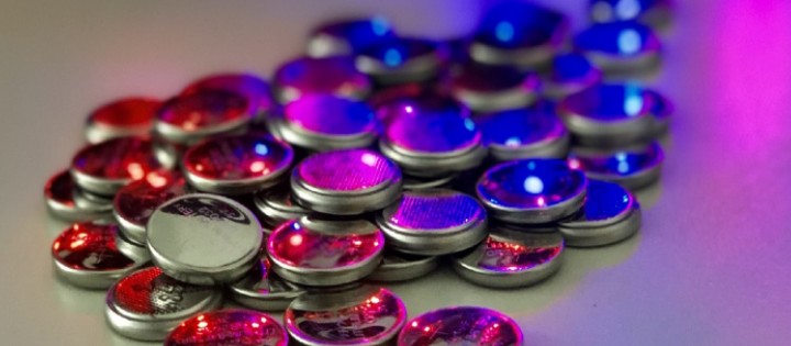 Close-up photograph of small purple, blue and pink iridescent metal spheres